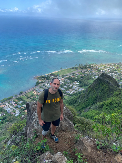 Wearing the FIT IS GOOD Tee in Military Green on an Oahu, Hawaii coastal ridge hike